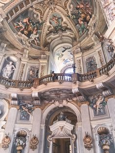 an ornate building with paintings on the ceiling