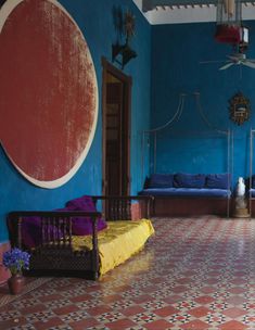 a living room with blue walls and colorful furniture