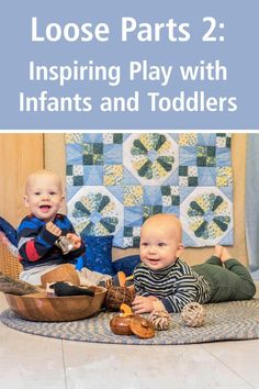 two babies playing with toys on the floor