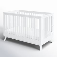 a white baby crib with no sheets on it's sides and the bottom half turned down