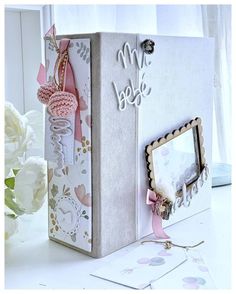 a white box with some pink decorations on it