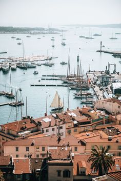 a harbor filled with lots of boats on top of it's sides next to tall buildings