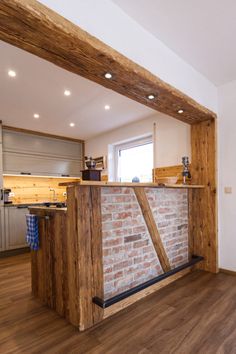 a kitchen with an island made out of wood and brick in the middle of it