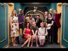 a group of people posing for a photo in front of an open door on a train