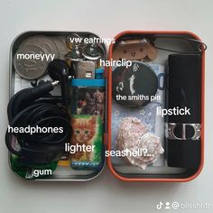 the contents of an electronic device in a metal container on a white surface with words describing them