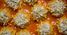 some meatballs covered in sauce and cheese