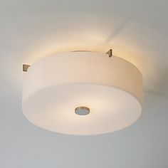 a ceiling light that is on in a room with white walls and flooring,