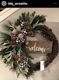 a wooden sign that says welcome with pine cones and plaid bows hanging on the front door