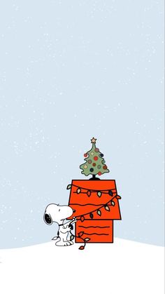 a charlie brown christmas tree on top of a red box with a dog in it