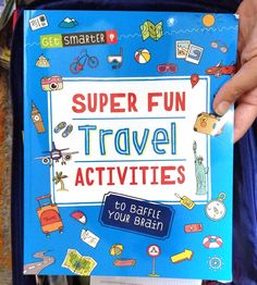 a person holding up a book that says super fun travel activities