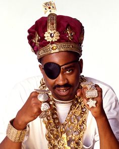 a man wearing sunglasses and a crown on his head with an ad for the brand above it