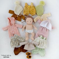 there is a doll with many different clothes on it