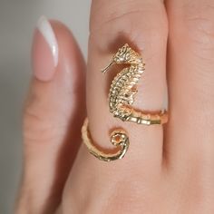 Dive into the enchanting depths of the ocean with our mesmerizing Seahorse Ring. Created using advanced 3D printing technology, this adjustable ring showcases the intricate beauty of a seahorse, capturing the essence of marine life. With its captivating design and adjustable fit, this ring is the perfect accessory for ocean lovers, bringing a touch of the sea's magic to your everyday style. Size: The ring at the tallest point is about 20mm. The band 2 mm round Gold Ocean Jewelry, Ocean Inspired Rings, Ocean Wedding Ring, Ocean Rings, Seahorse Ring, Sea Ring, Seahorse Jewelry, Valentine Card Crafts, Animal Rings Jewelry