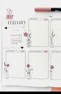 an open planner with flowers in vases on it and a pink pen next to it