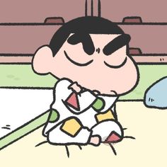 a cartoon boy sitting on the ground with his eyes closed