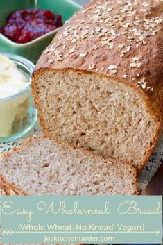 a loaf of whole wheat bread sitting on top of a table next to butter and jelly