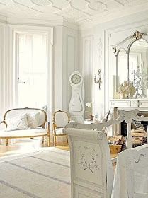 a living room filled with furniture and mirrors