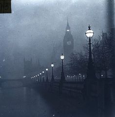 the big ben clock tower towering over the city of london on a foggy day