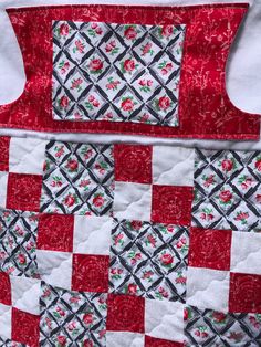 a red and white quilt with flowers on it