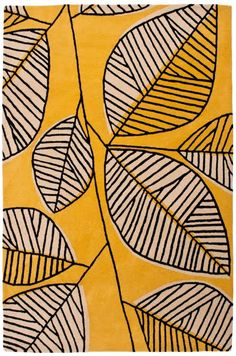 a yellow rug with black and white leaves on it