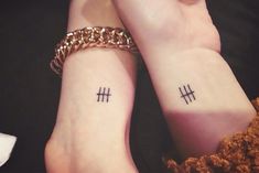 two people with matching tattoos on their wrists