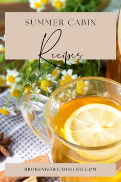 a glass pitcher filled with lemonade next to a cup of tea on top of a table