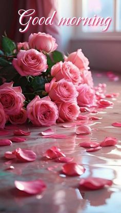 pink roses on the ground with rose petals in front of it and words good morning