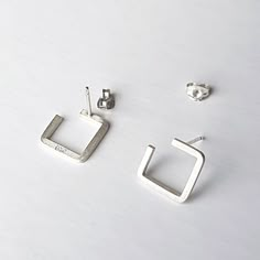 A pair of minimalist silver stud earrings, uniquely handcrafted using traditional silversmithing techniques in my London workshop. All custom to your taste, they can take up to 2 business days to be dispatched.  ‣‣ Clean design ideal for an everyday look ‣‣ Fully handmade one-of-a-kind treat for yourself or your loved ones ‣‣ Gift boxed with a personalised message card ‣‣ Free, fast, and secure delivery  ‣‣ 13% OFF with this coupon (excluding Sale items):  https://www.etsy.com/uk/shop/AndyKashtanJewellery?coupon=1STPURCHASE MORE DETAILS: These unique contemporary stud earrings are made by hand from high-quality recycled sterling silver square wire using traditional silversmithing techniques in my London studio. A square is shaped and soldered to the pin. After that, the components are then Minimalist Hallmarked White Gold Earrings, Minimalist Everyday Earrings, Minimalist Everyday Hallmarked Earrings, Silver Minimalist Hallmarked Earrings, Silver Hallmarked Minimalist Earrings, Everyday Minimalist 925 Stamped Earrings, Everyday Minimalist Stamped 925 Earrings, Minimalist Silver Earrings For Gift, Modern Sterling Silver Earrings As Gift