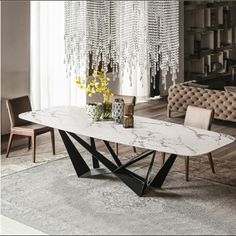 a marble dining table with modern chairs and chandelier