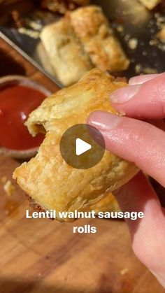 a person is holding a piece of food in their hand with the words lenti walnut sausage rolls on it