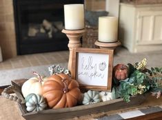 a table with candles and pumpkins on it