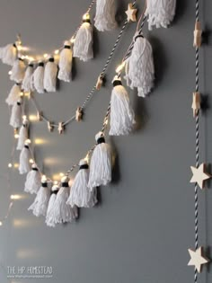 the wall is decorated with white tassels and lights