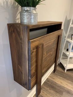 a potted plant sitting on top of a wooden cabinet