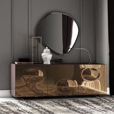 a large mirror sitting on top of a wooden cabinet