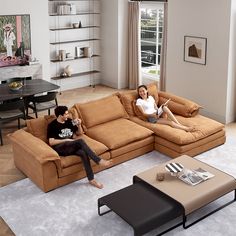 two people sitting on a couch in a living room