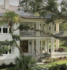 a large white house surrounded by trees and grass