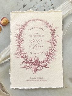 a wedding save the date card on top of a piece of paper