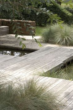 a wooden dock sitting next to a small pond