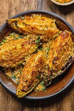 grilled artichokes with parmesan cheese and herbs on a plate