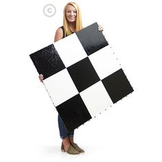 a woman holding up a black and white checkered board