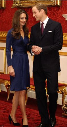 prince william and kate are standing next to each other in front of red carpeted walls