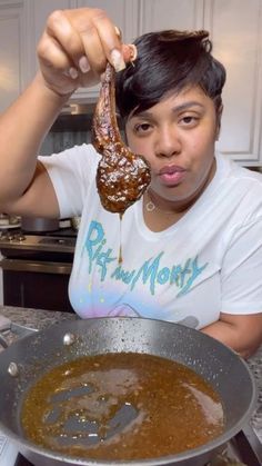 a woman holding up a piece of food in front of her face