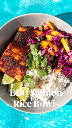 a bowl filled with rice, meat and veggies on top of a blue table