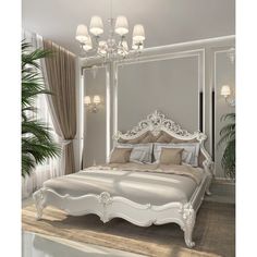 a white bed sitting under a chandelier next to a potted palm tree