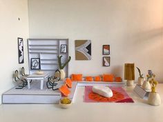 a white table topped with lots of orange and white decorations