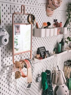 there are many hats and other items on the wall in this room that is organized