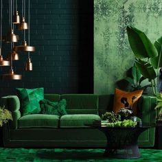 a living room filled with green furniture and lots of plants on top of the floor