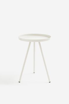 a white side table with two legs and a small round top on one end, in front of a plain background