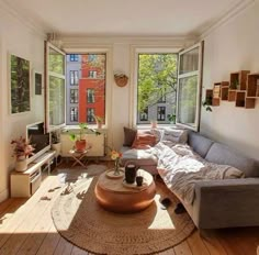 a living room filled with furniture and lots of windows