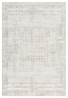 a white rug with an intricate design on the front and back side, in shades of gray